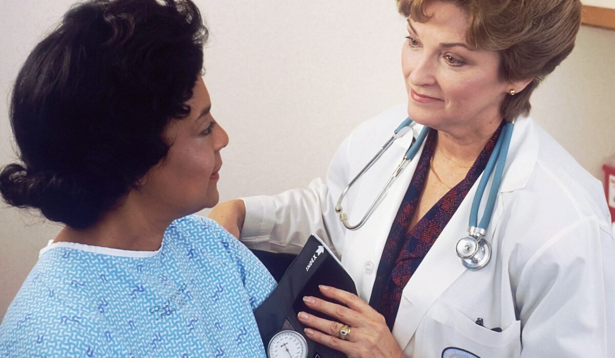 a woman with a stethoscope talking to another woman