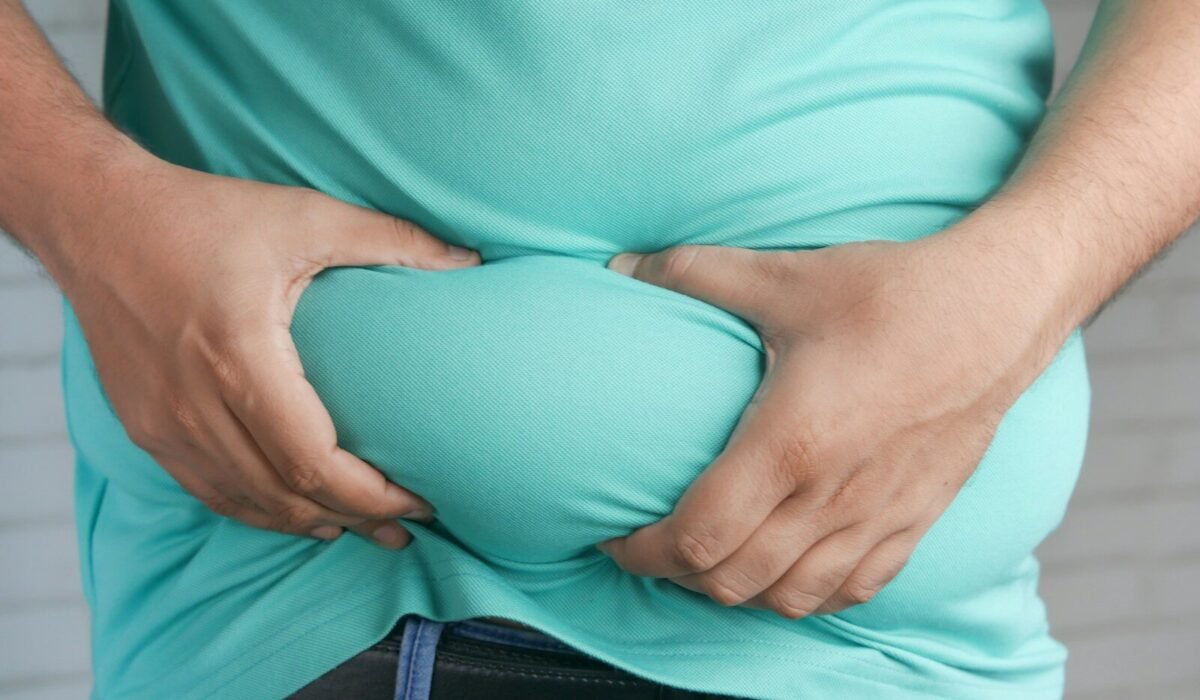 a man holding his stomach with his hands