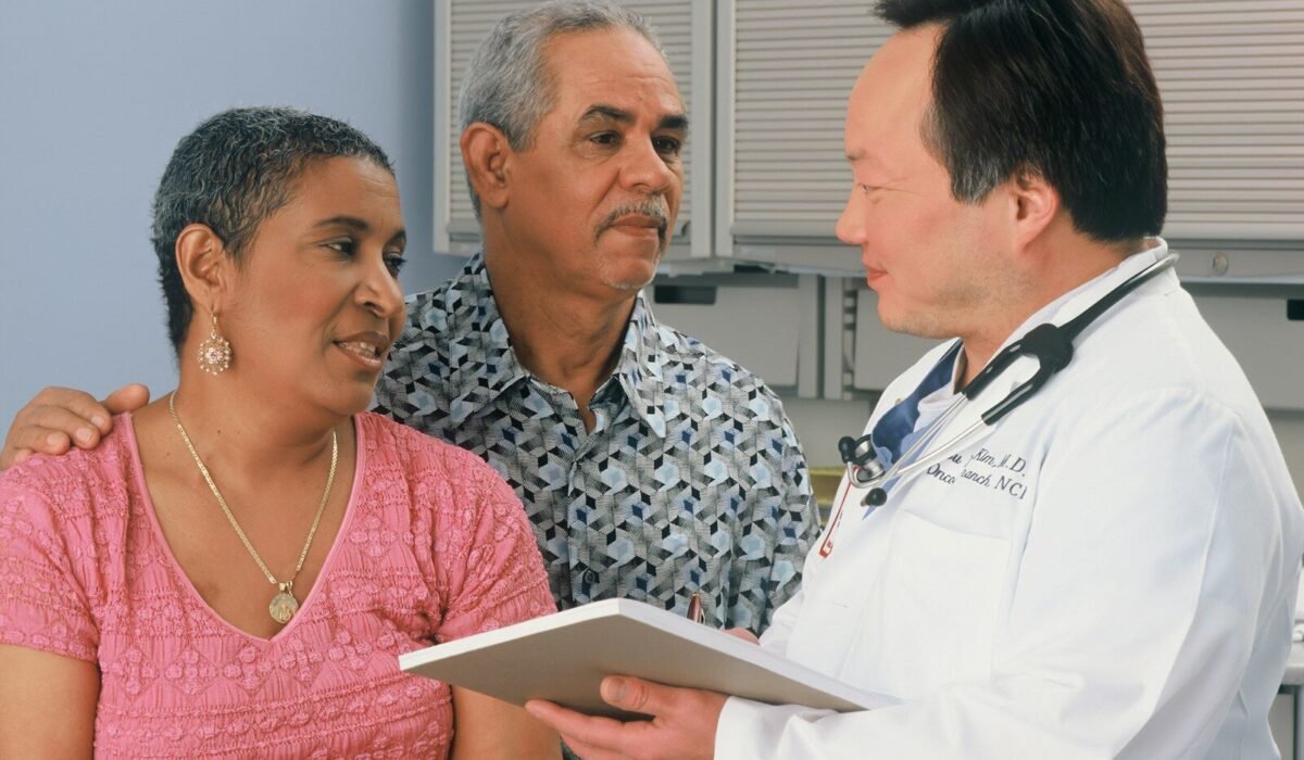 man in white button up shirt holding white tablet computer