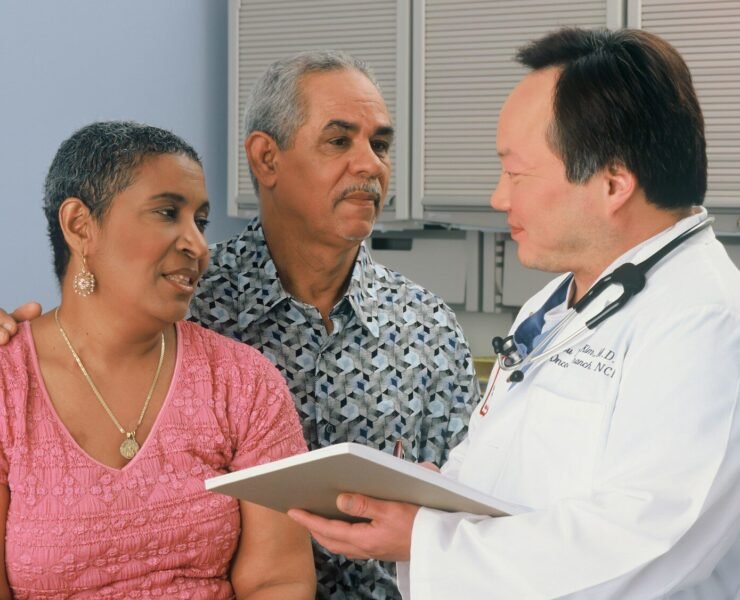 man in white button up shirt holding white tablet computer