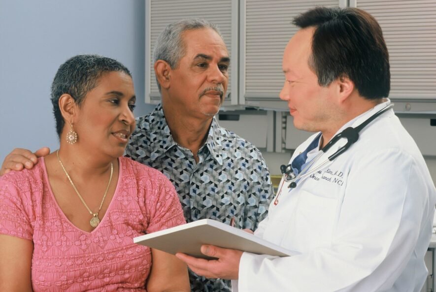 man in white button up shirt holding white tablet computer
