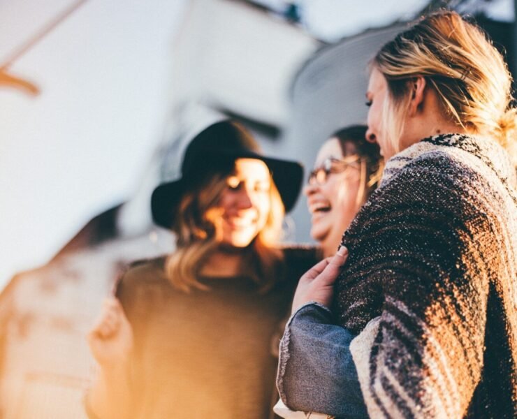 people laughing and talking outside during daytime